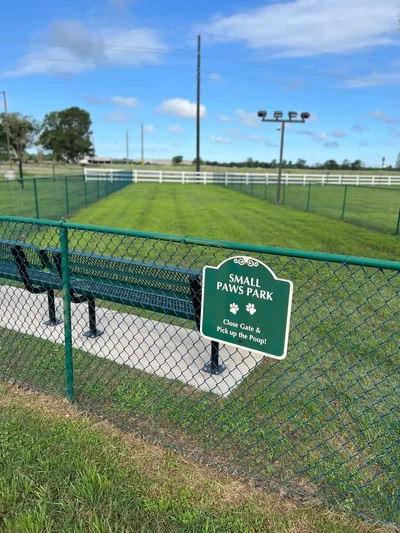 Fenced grass lawn and park benches